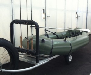 Optional rod racks and float boat loaded on to the open slat trailer bed.