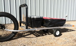 Bicycle trailer, 6' showing float boat in its carry bag and the optional storage and fly rod holder, open slat standard bed.